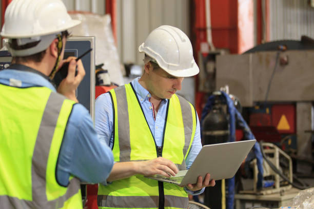 istock Senior engineers working together in factory. 1394870638