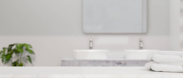 istock Modern white bathroom countertop with towels and copy space 1394871373