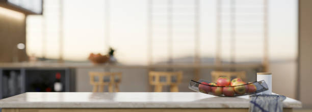 istock Modern white marble kitchen countertop with a tray of apples and copy space 1394871384