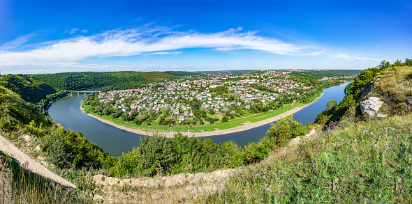 Large panorama. A horseshoe-shaped river bend. meander in a river. Panoramic view from above city Zaleshchiki in the Dnister river, Ukraine