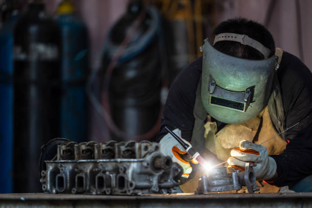 istock Industrial welder worker metal welding steel works using argon arc welding machine to weld steel at factory, Metalwork manufacturing and construction maintenance. 1394879910