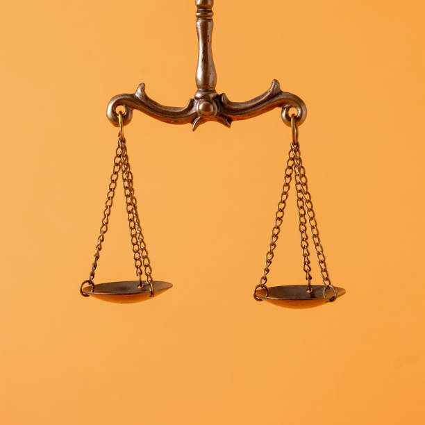 istock Pendulum scales over an orange background with copyspace 1394883387