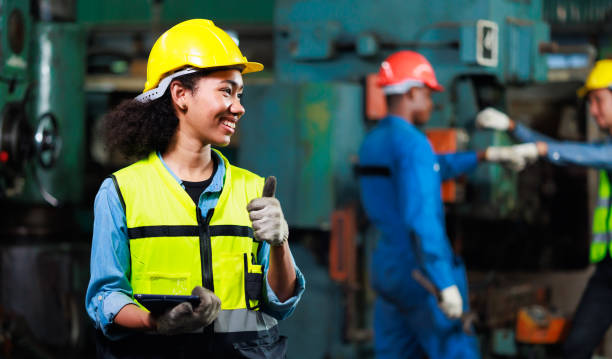 thumps up black woman. portrait african american female engineer worker wearing safety hard hat helmet. metal lathe industrial manufacturing factory - thumps up imagens e fotografias de stock