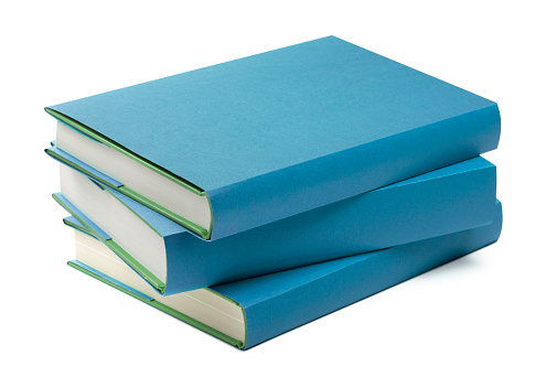 A stack of old yellowed hardcover books isolated on a white background