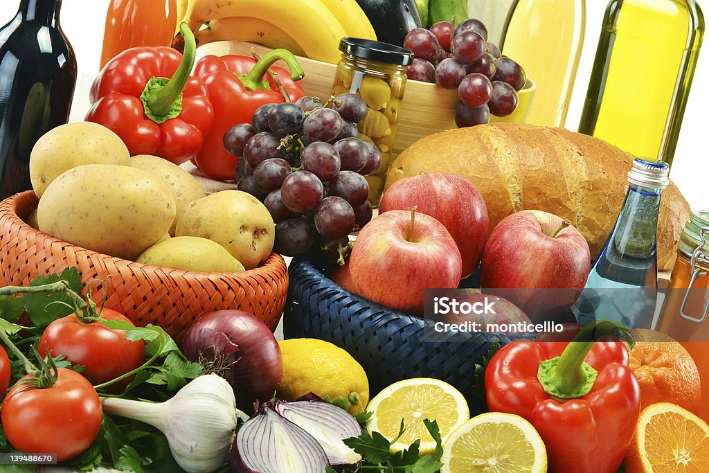 Composition with groceries and basket Composition with groceries and basket. Vegetables, fruits, wine and bread. Apple - Fruit Stock Photo