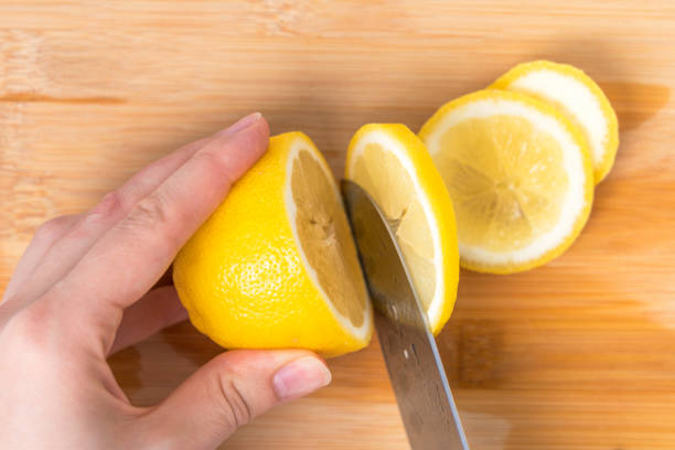 istock Cook slices lemon slices, top view 1394886893