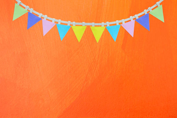istock Flag garland on abstract orange wall texture background 1394886938