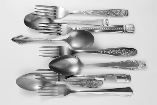 Laid out cutlery on white background. Set of forks and spoons.