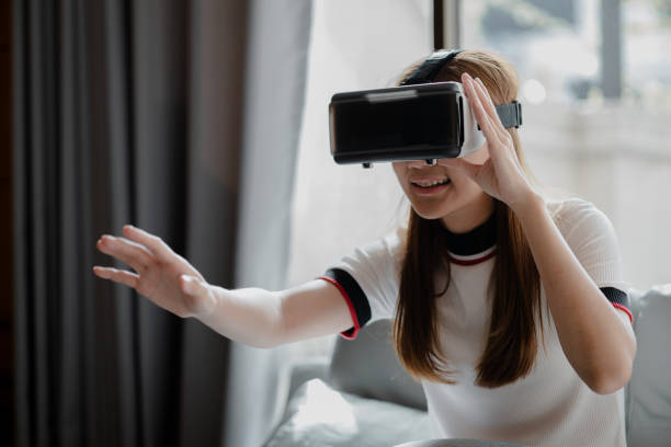 istock Woman wearing virtual reality glasses to use the technology of the future, using virtual reality technology to facilitate and enjoy leisure, boundless imagination, Smartphone using with VR headset. 1394888810