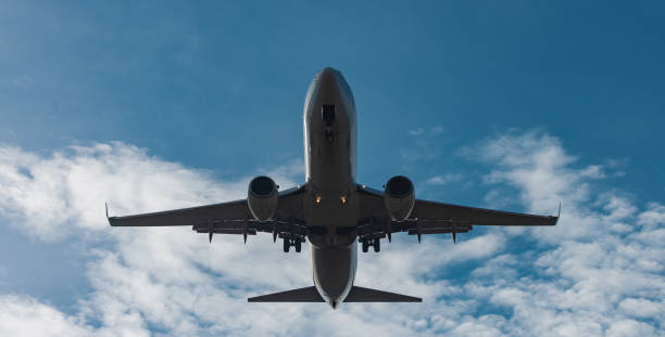 istock Frontal view of modern twin jet engine descending from the cloud 1394890591