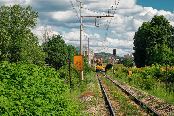 istock Train track under maintenance. Service of catenary on a mainline train track on a summer day. 1394890751