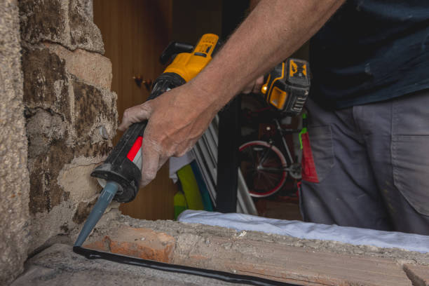 istock Modern window instalation in an old house. Worker applying seala 1394891477