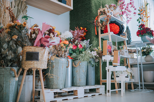 flower shop interior with rack , shelf, vases and flowers display