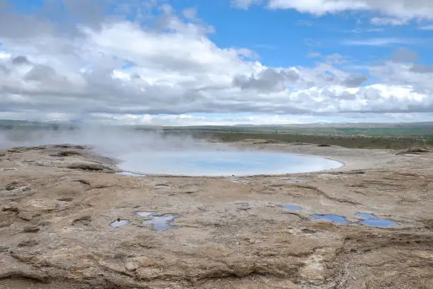 Photo of geysir in the Haukadalur Valley geothermal area, Iceland. Boiling hole area (geyser), hot springs