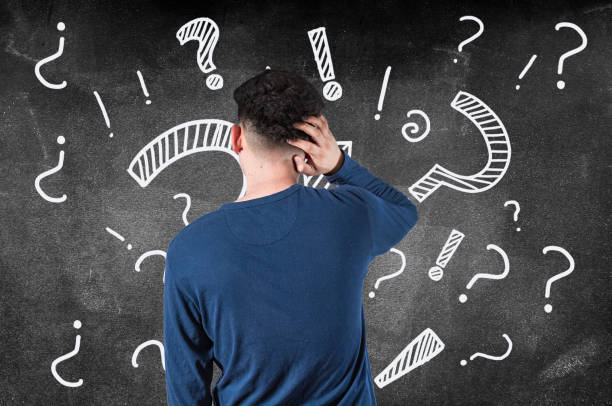Puzzled man from back of a blackboard, puzzled man scratching his head, confused man from back scratching his head, person from back scratching his head puzzled