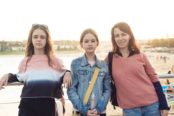 Family Portrait of Mothers and two daughters at the beach