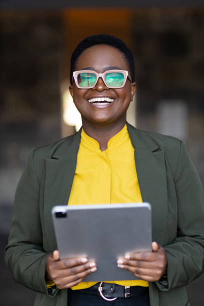 istock Happy young black woman holding tablet 1394895610