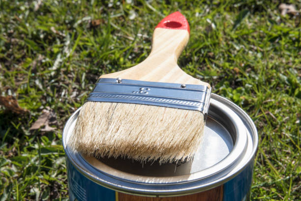 istock Clean paint brush on closed color can 1394895813