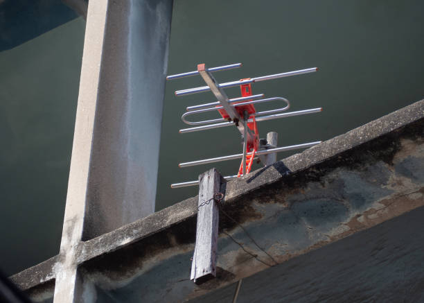 istock Vintage analog TV antenna mounted on an old house 1394895829