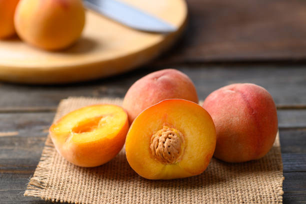istock Peach fruit on wooden background 1394896942