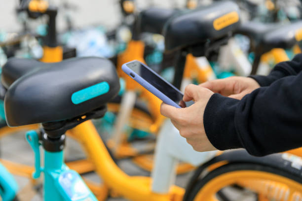 istock Hand using smartphone scanning the QR code of shared bike in city 1394898248