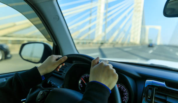istock People driving car on city road 1394898756