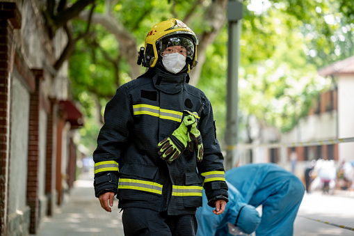 Chinese firefighters in Shanghai inspect an alarm during a now months-long city wide COVID-19 lockdown in China's largest city.