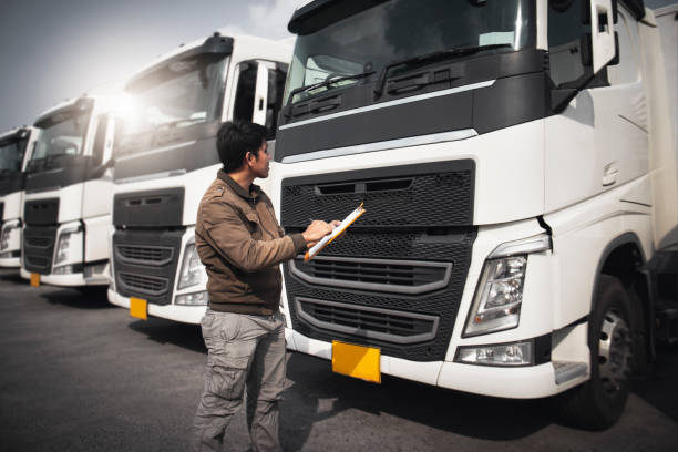 istock Truck Driver is Checking the Semi Truck's Engine Maintenance Checklist. Inspection Safety Before Driving. Shipping Cargo Freight Truck Transport. 1394899366