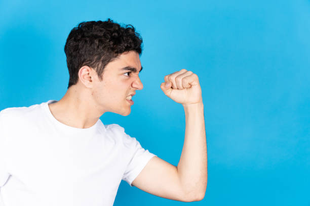istock Aggressive hispanic teenager boy menacing 1394902167