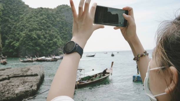 New normal travel 2022 Young thai Asian generation Y influencer exciting moment using smart phone record travel video vlog at maya bay krabi thailand