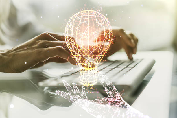 istock Double exposure of creative light bulb hologram with hands typing on laptop on background, research and development concept 1394904810