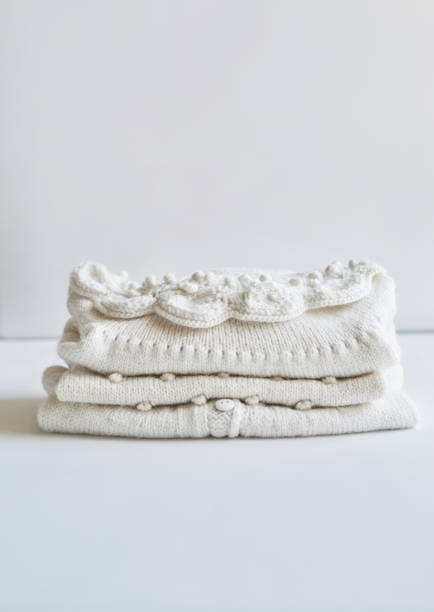 istock Stack of knitted clothes. Baby clothes. Needlework, hobby, knitting, handwork. 1394905576