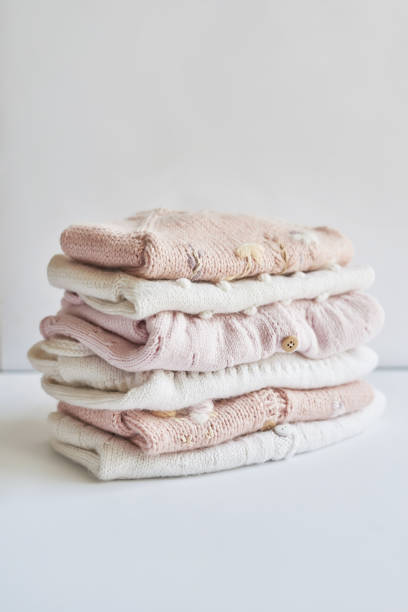 istock Stack of knitted clothes. Baby clothes. Needlework, hobby, knitting, handwork. 1394905590