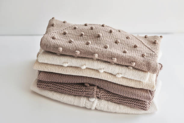 istock Stack of knitted clothes. Baby clothes. Needlework, hobby, knitting, handwork. 1394906525