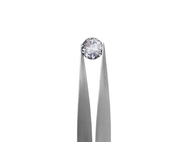 istock Diamond on white background held in diamond tweezers 1394906530