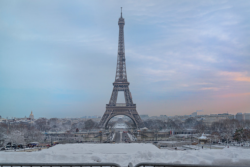 The Eiffel Tower in a snowstorm with the pont d’Iéna and the River Seine in the foreground.