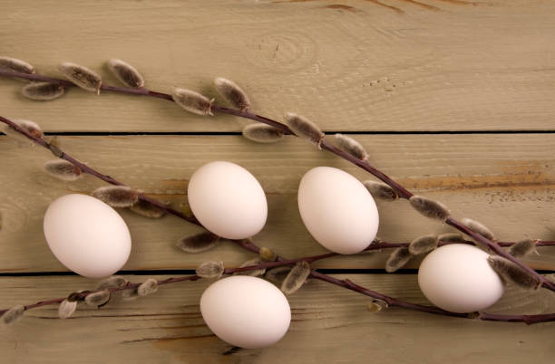 istock Eggs and willow on a wooden background 1394910315