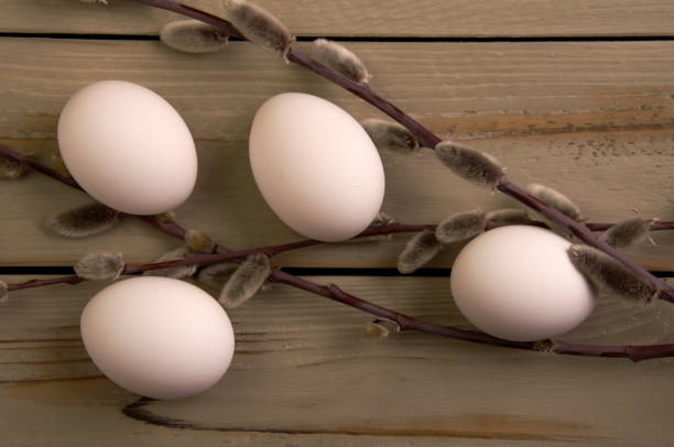 istock Eggs and willow on a wooden background 1394910324