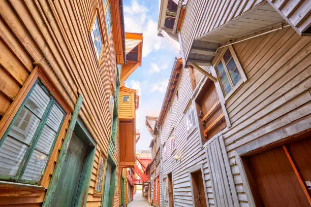 Narrow street between wooden houses in Bryggen district, Bergen, Norway
