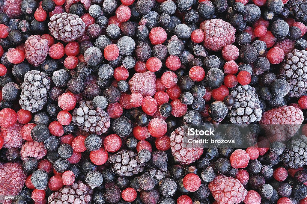 Close up of frozen mixed fruit  - berries Close up of frozen mixed fruit  - berries - red currant, cranberry, raspberry, blackberry, bilberry, blueberry, black currant Frozen Stock Photo