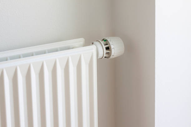 istock Adjusting knob on thermostat on radiator valve to save energy 1394912263