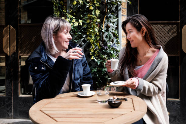 istock Two multiracial mature women friends having a coffee. 1394912321