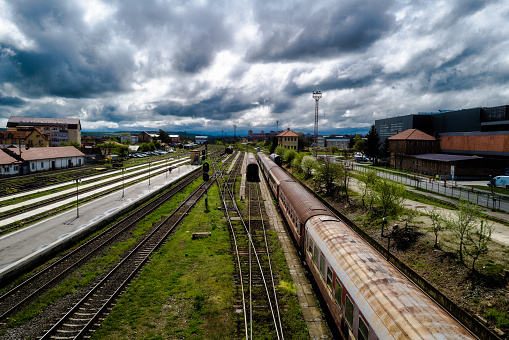 Empty subway platform. View of the metro rails of the Norwegian capital. Blue sky with clouds and fjords behind. Open metro station in Oslo.