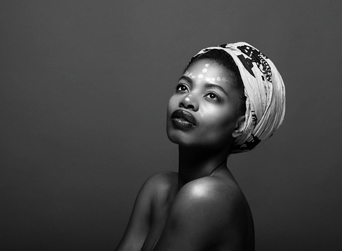Black And White Studio Shot Of African Woman Against Black Background