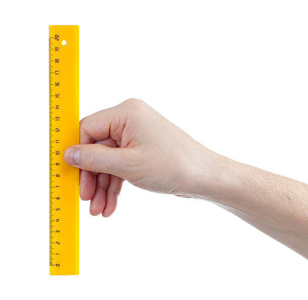 istock yellow centimetres ruller in hand isolated on white 139491378