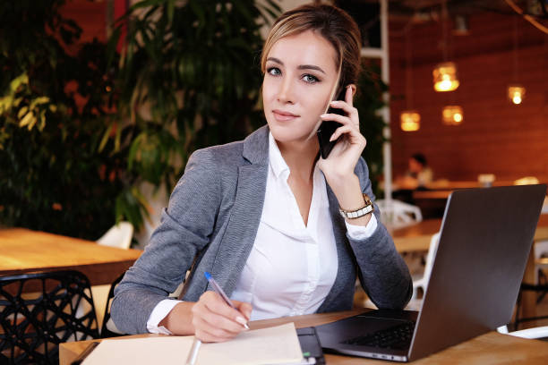 istock Happy woman using chatting with mobile and use laptop computer 1394916946