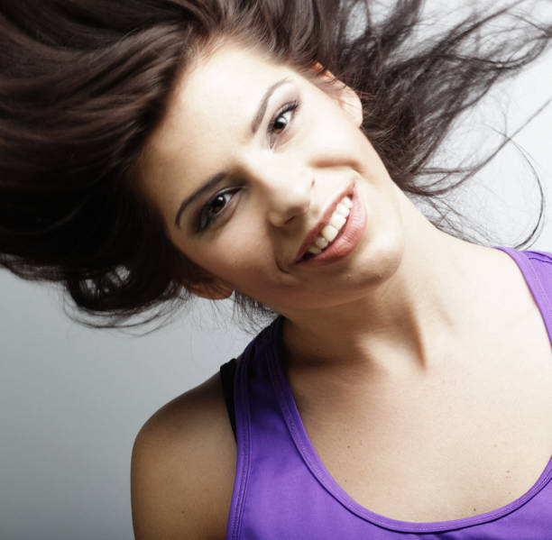 young Woman with hair motion on white background, close up