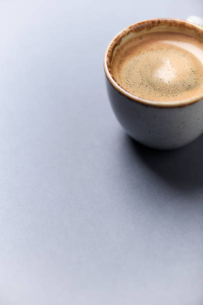 istock Cup of coffee on paper background. Close up. Copy space. 1394917074