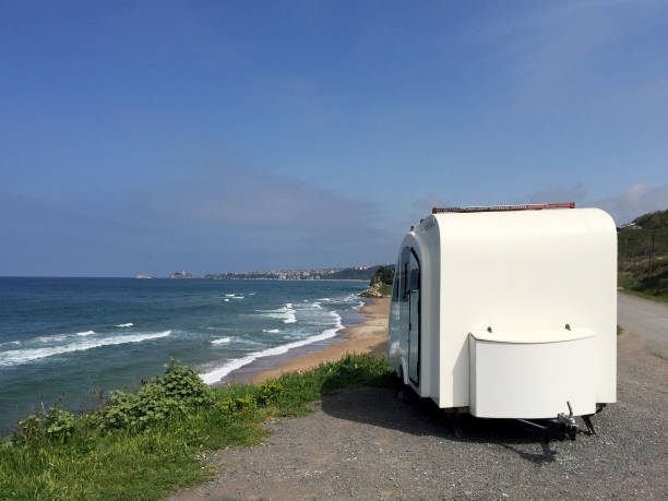 istock Caravan at the roadside with seascape 1394918013