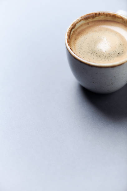 istock Cup of coffee on paper background. Close up. Copy space. 1394918089
